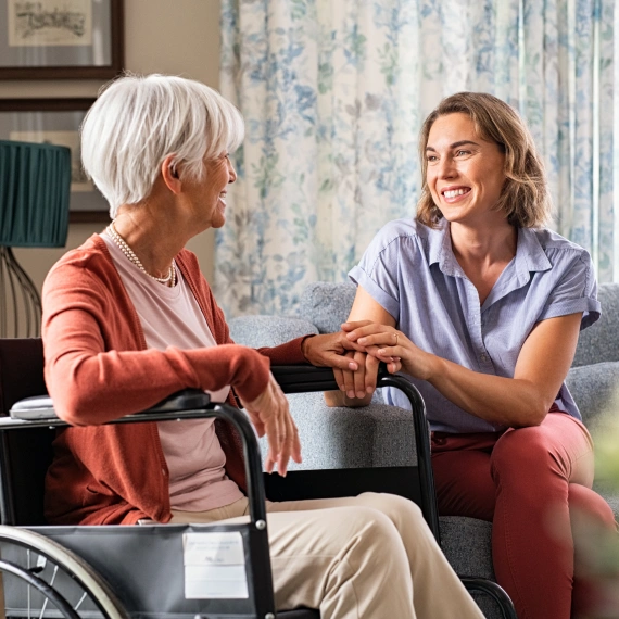 A woman sitting on the ground with another person.